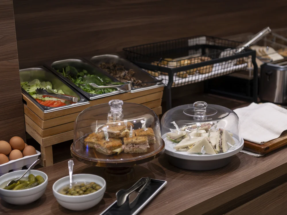 Buffet counter with salads, sandwiches, cheese, eggs, pickles and olives